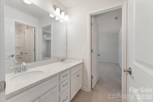 a spacious bathroom with a double vanity sink mirror and double