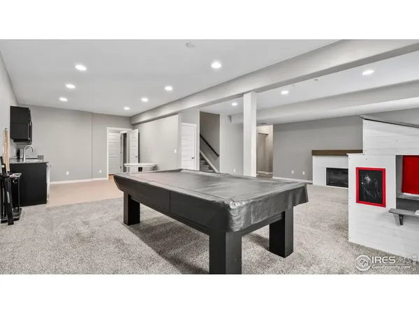 a open kitchen with stainless steel appliances granite countertop a living room dining table chairs and couches