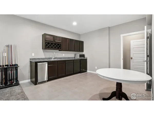 a kitchen with a sink a table and chairs