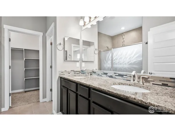 a bathroom with a sink double vanity and a mirror