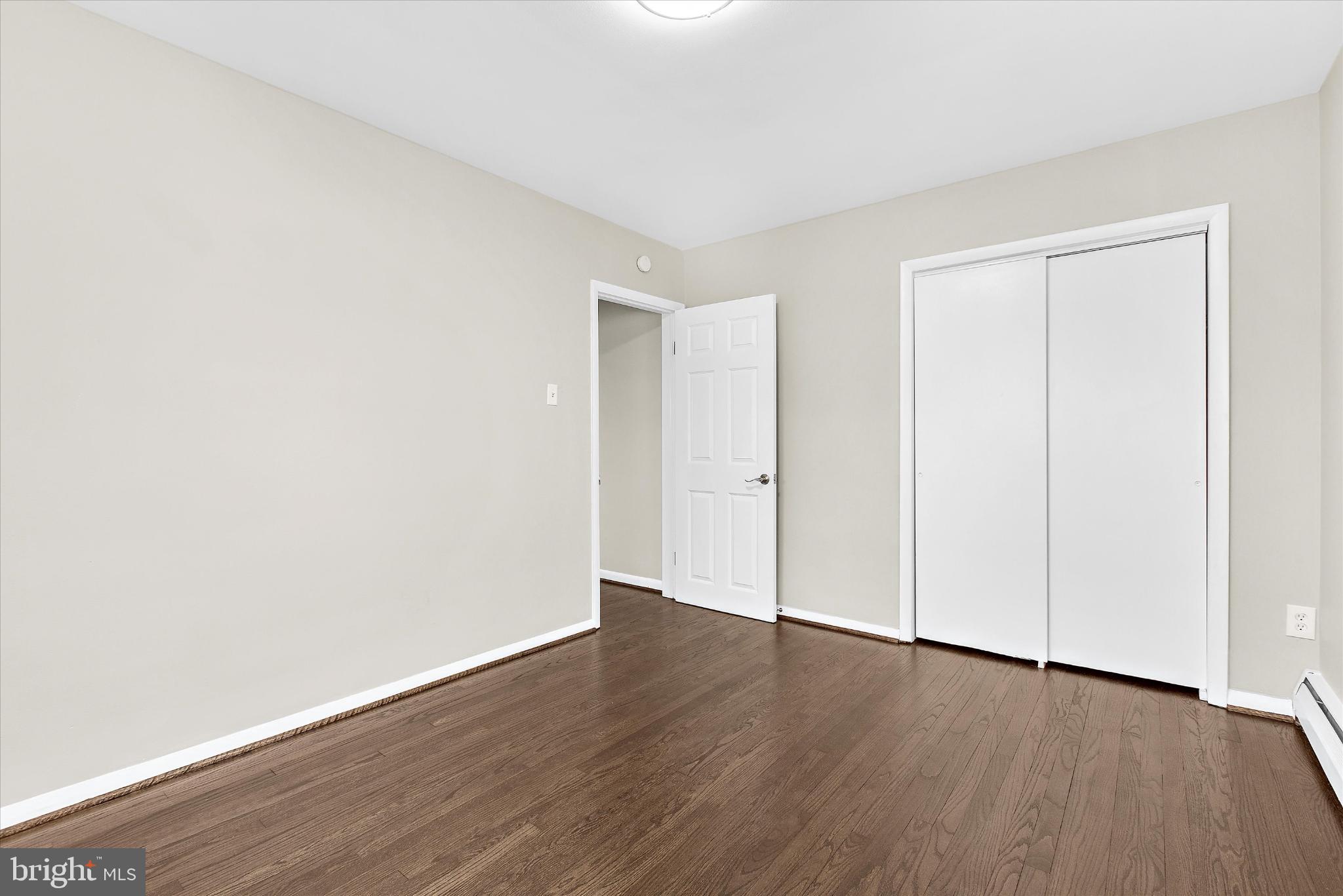 8421 Spring Road Pasadena, MD 21122 - Photo 15 of 30 an empty room with wooden floor and closet