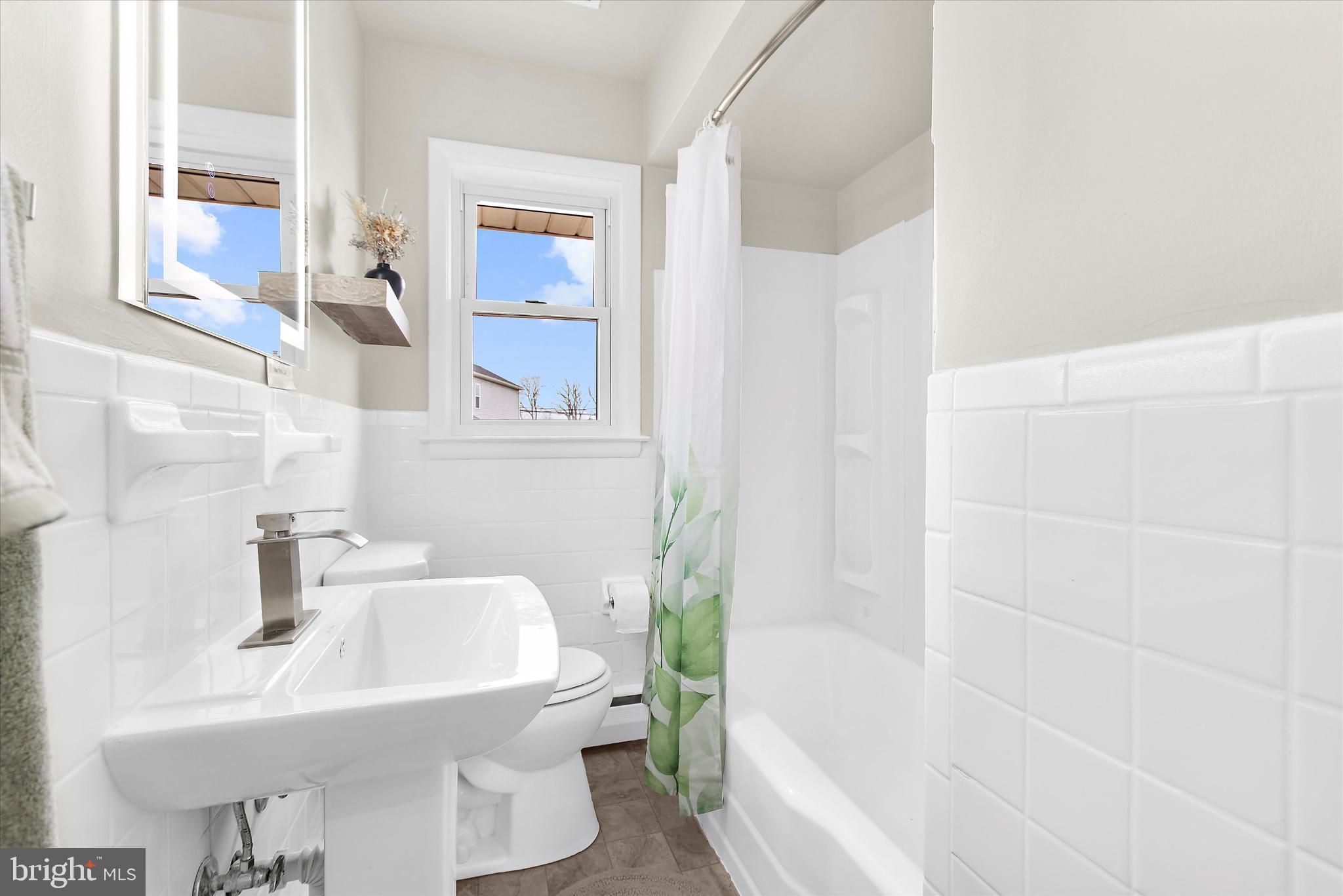 8421 Spring Road Pasadena, MD 21122 - Photo 17 of 30 a bathroom with a sink and a bathtub