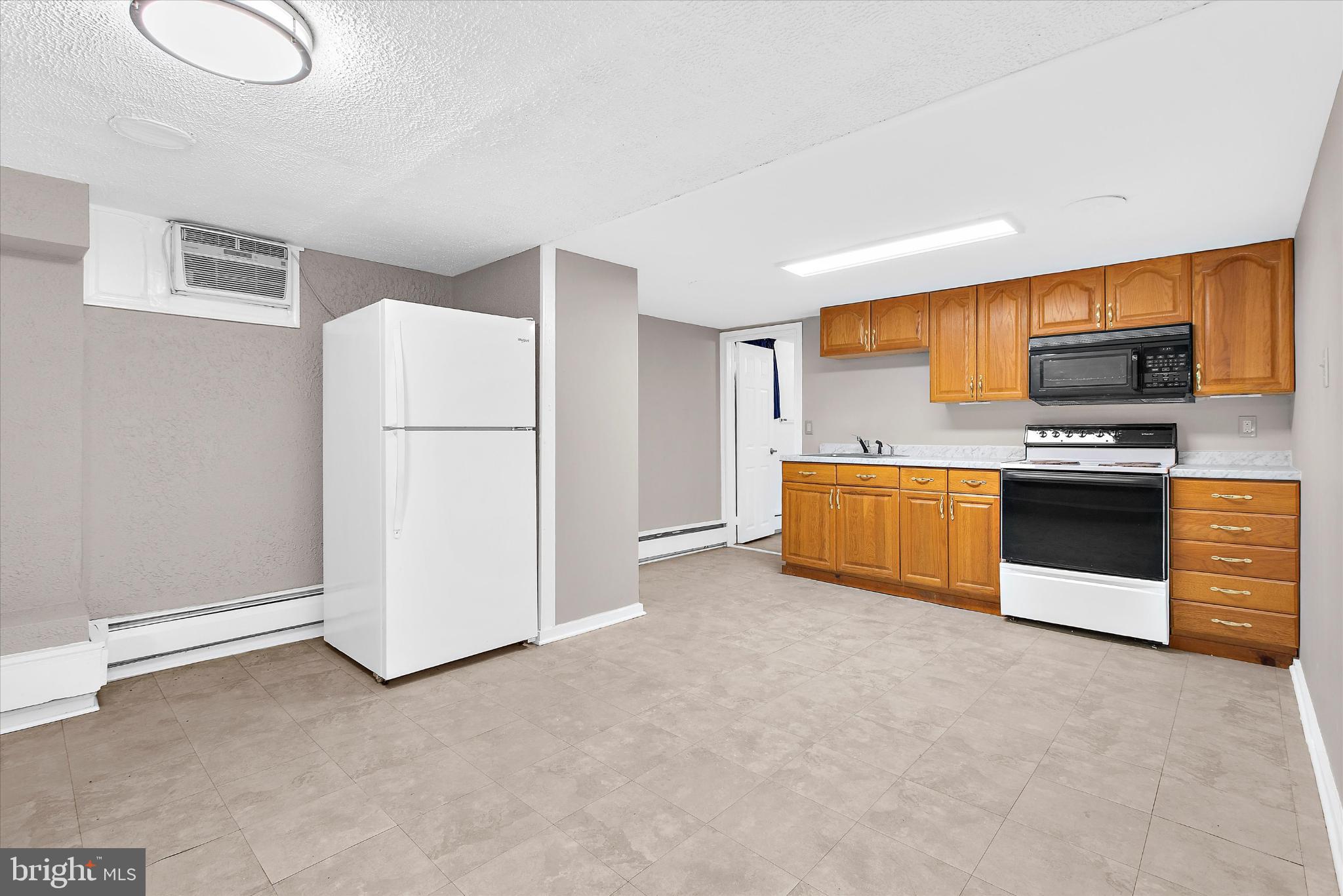 8421 Spring Road Pasadena, MD 21122 - Photo 18 of 30 a kitchen with stainless steel appliances a refrigerator and a stove top oven