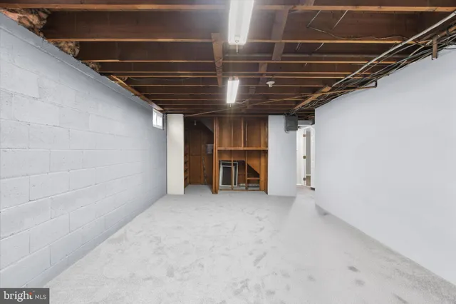 a view of room with refrigerator and cabinet