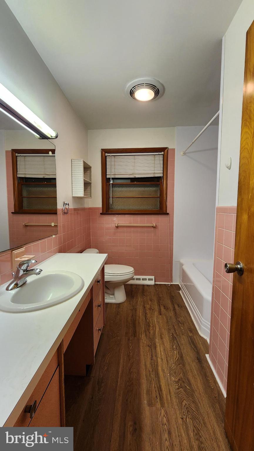 202 Holly Street Glassboro, NJ 08028 - Photo 12 of 14 a bathroom with a sink a toilet a mirror and shower