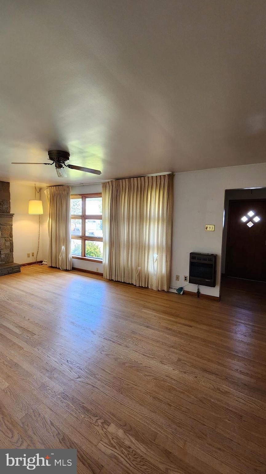 202 Holly Street Glassboro, NJ 08028 - Photo 8 of 14 an empty room with windows and fireplace