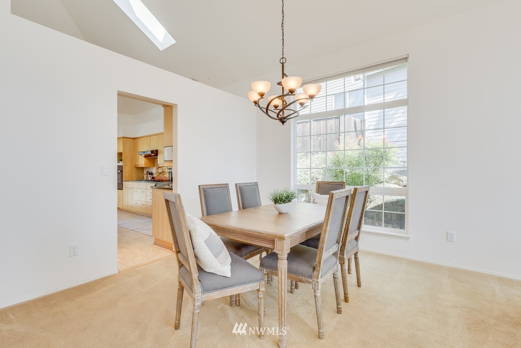 5006 Northeast 18th Court Renton, WA 98059 - Photo 8 of 35 a view of a dining room with furniture a chandelier and wooden floor