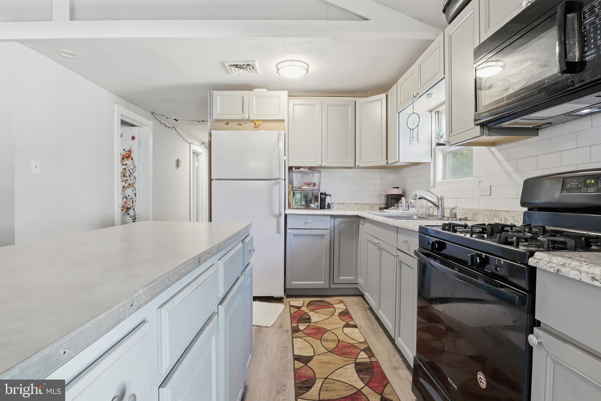 1744 Ridge Road York Springs, PA 17372 - Photo 13 of 30 a kitchen with a sink stove and refrigerator