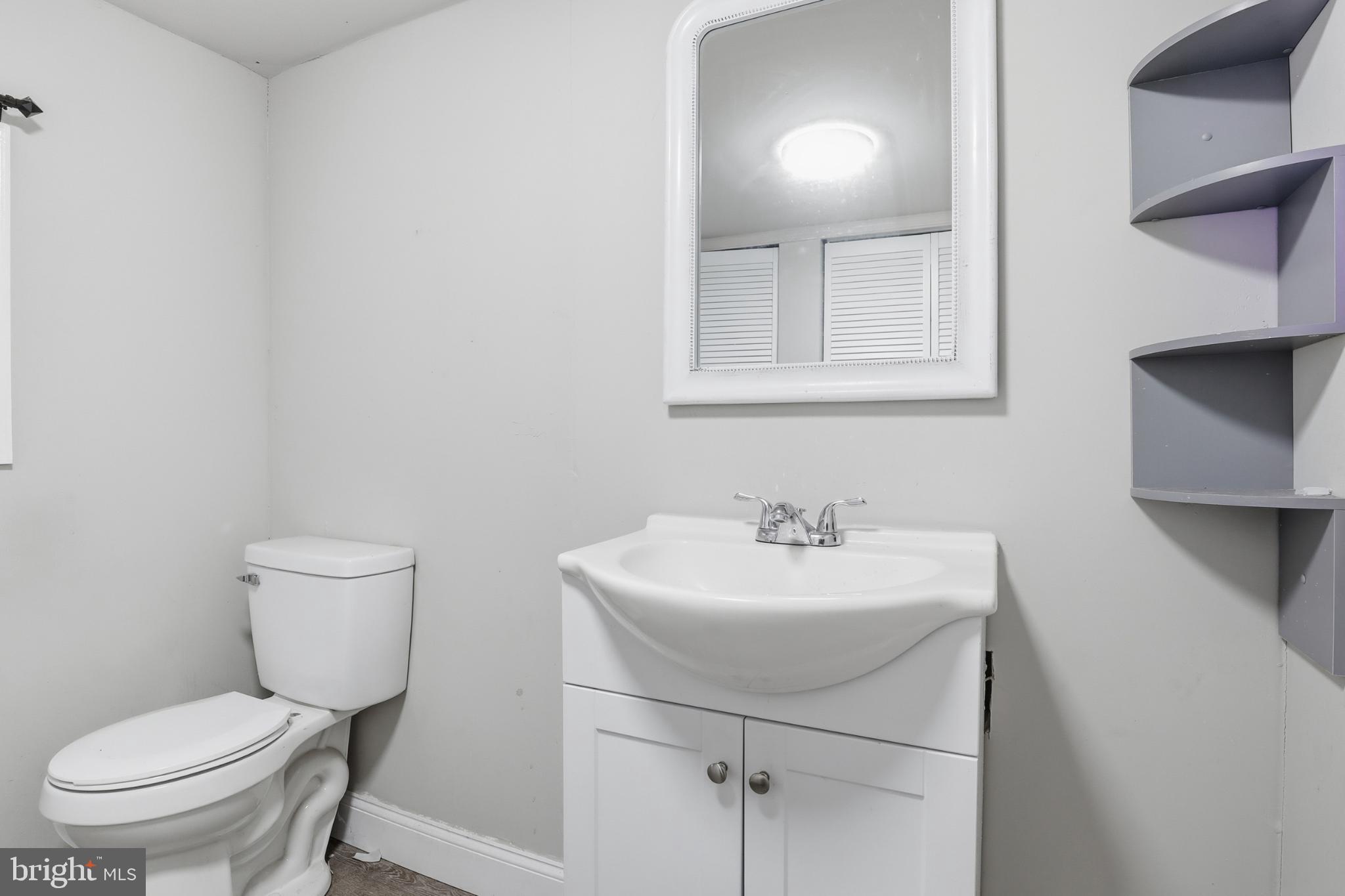 1744 Ridge Road York Springs, PA 17372 - Photo 21 of 30 a bathroom with a toilet a sink and mirror