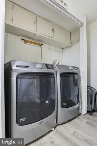 a white bath tub sitting next to a white sink and vanity