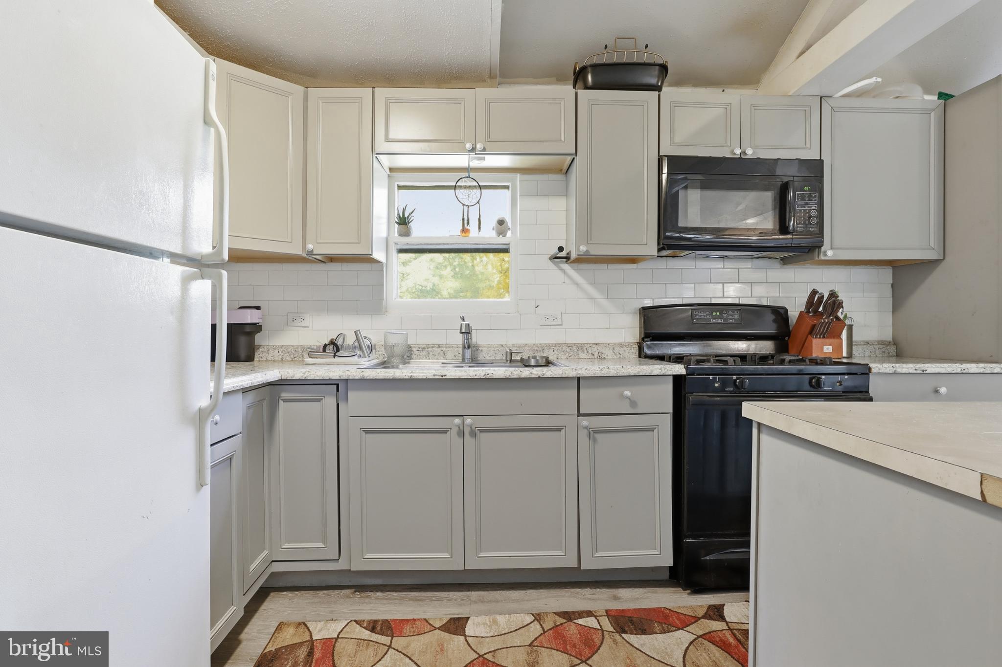 1744 Ridge Road York Springs, PA 17372 - Photo 10 of 30 a kitchen with stainless steel appliances granite countertop a sink stove and microwave