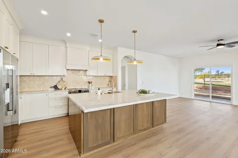 a kitchen with kitchen island a sink stainless steel appliances and cabinets