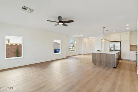 a view of kitchen and hall with wooden floor