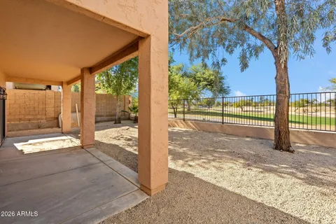 a view of a porch with a floor to ceiling window next to a yard