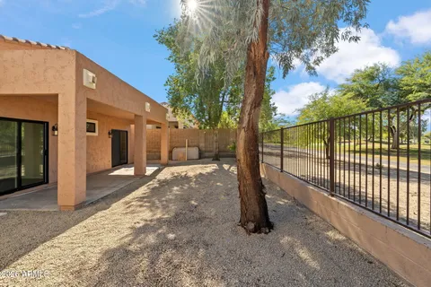 a view of a house with backyard and trees