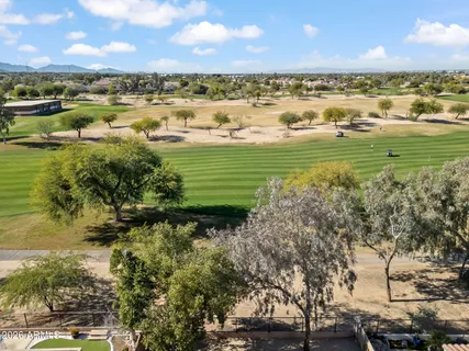 a view of a city with lots of residential buildings ocean and trees in the background
