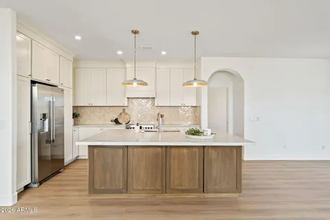 a large kitchen with kitchen island a sink stainless steel appliances and cabinets
