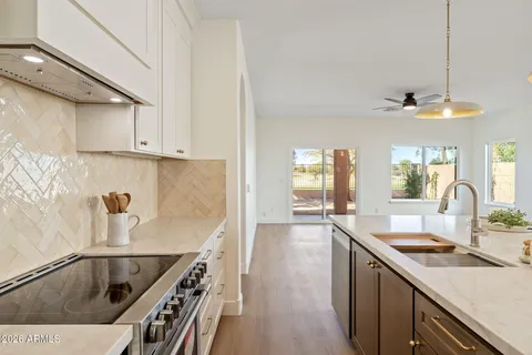 a kitchen with a sink a stove and cabinets