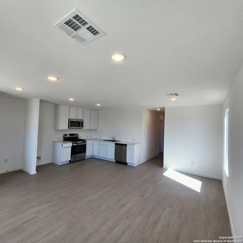 a view of a kitchen with a sink and a stove top oven
