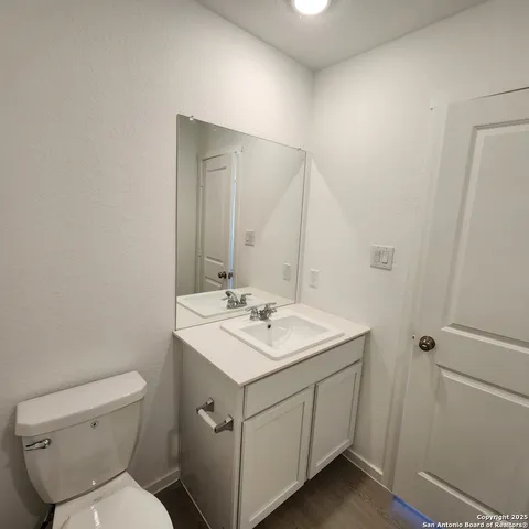 a bathroom with a sink toilet and mirror