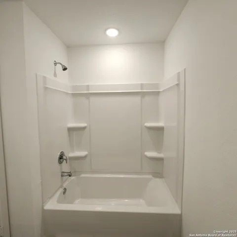 a bathroom with a bathtub and shower