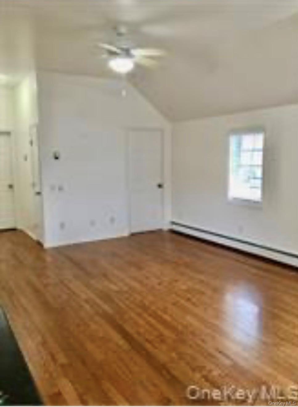 13 Spring Street, Unit 2A Warwick, NY 10990 - Photo 14 of 20 an empty room with wooden floor and windows