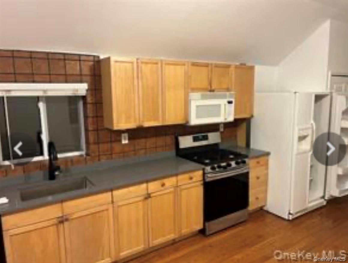 13 Spring Street, Unit 2A Warwick, NY 10990 - Photo 16 of 20 a kitchen with stainless steel appliances granite countertop a stove a sink and a refrigerator