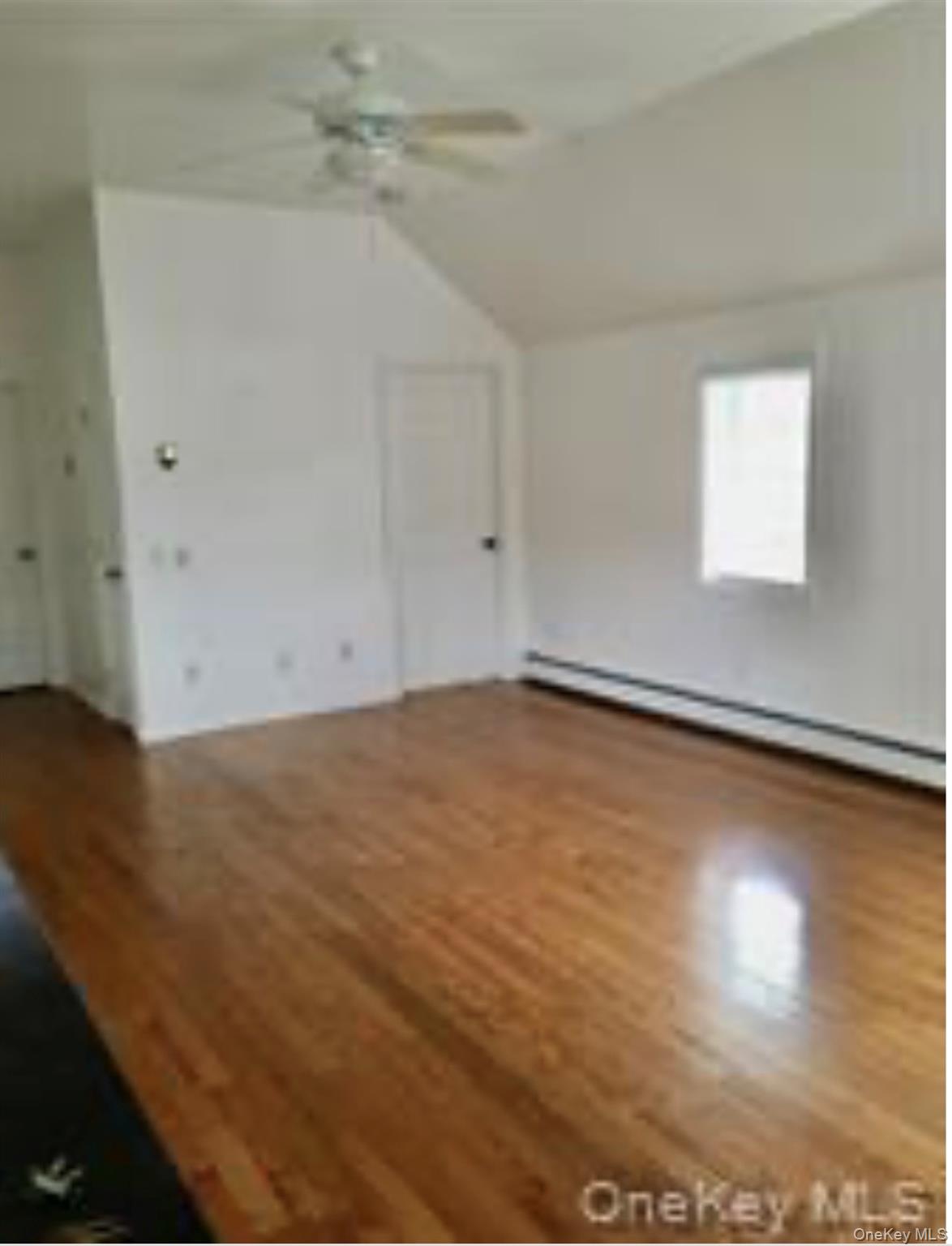 13 Spring Street, Unit 2A Warwick, NY 10990 - Photo 2 of 20 an empty room with wooden floor and windows