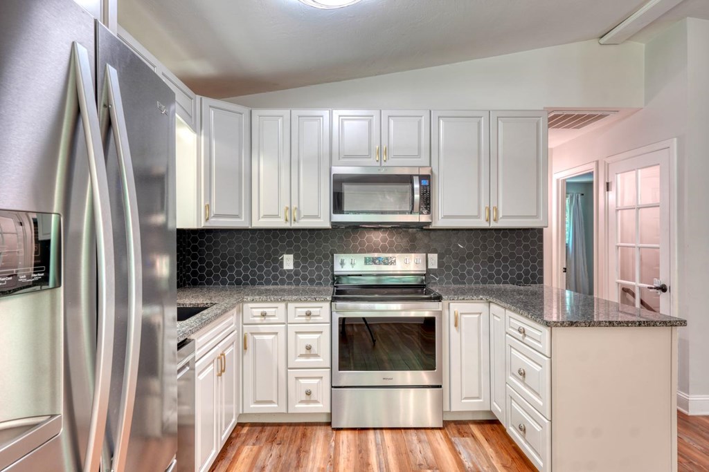 45 Mountain Stream Road Murphy, NC 28906 - Photo 9 of 33 a kitchen with white cabinets and stainless steel appliances