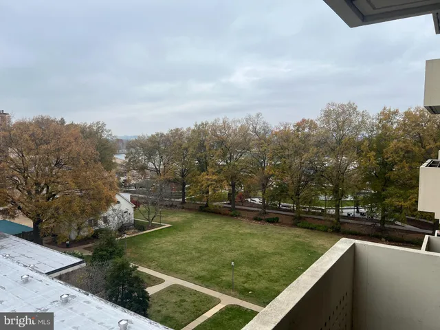 a view of a swimming pool with a yard and sitting area