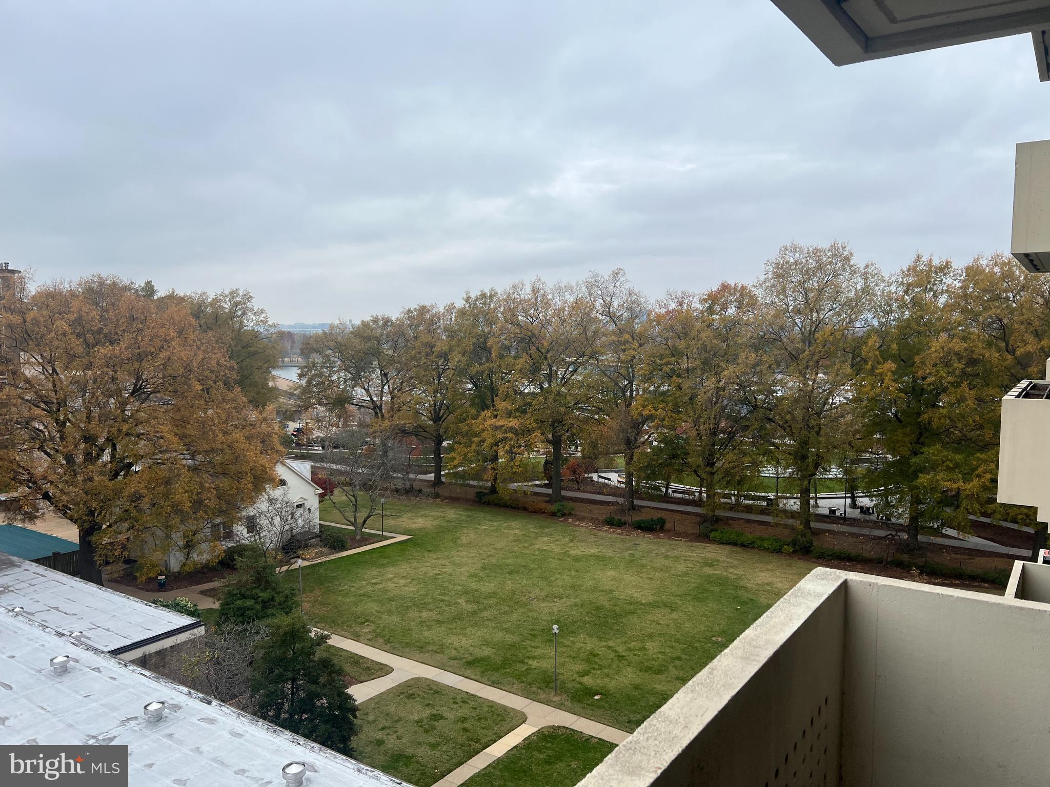 a view of a swimming pool with a yard and sitting area