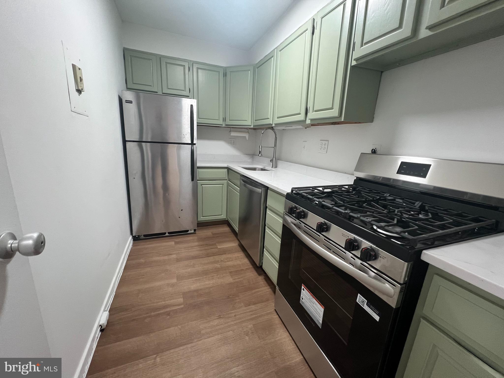 490 M Street Southwest, Unit 505 Washington, DC 20024 - Photo 4 of 12 a kitchen with a stove a refrigerator and a sink