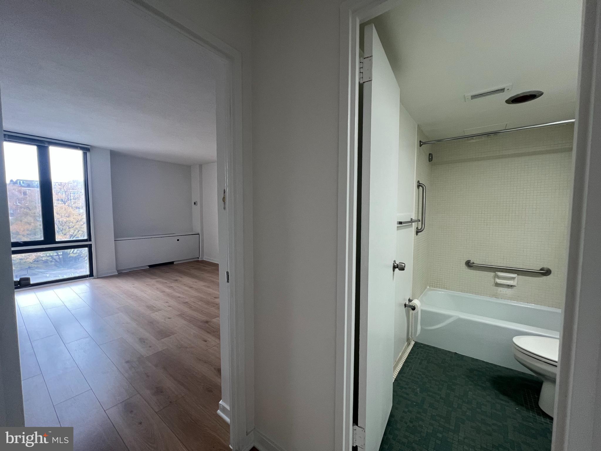 490 M Street Southwest, Unit 505 Washington, DC 20024 - Photo 8 of 12 a bathroom with a tub shower and toilet