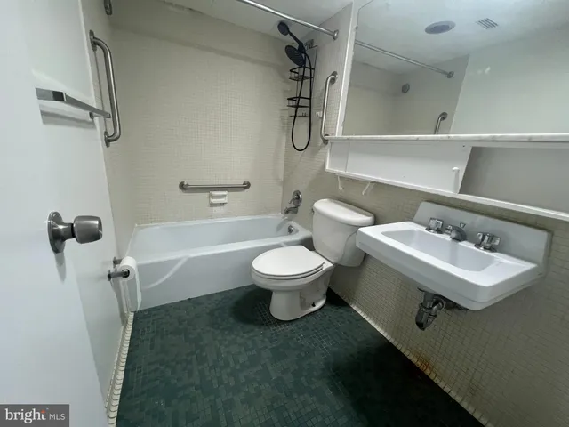 a bathroom with a sink a toilet and a bathtub