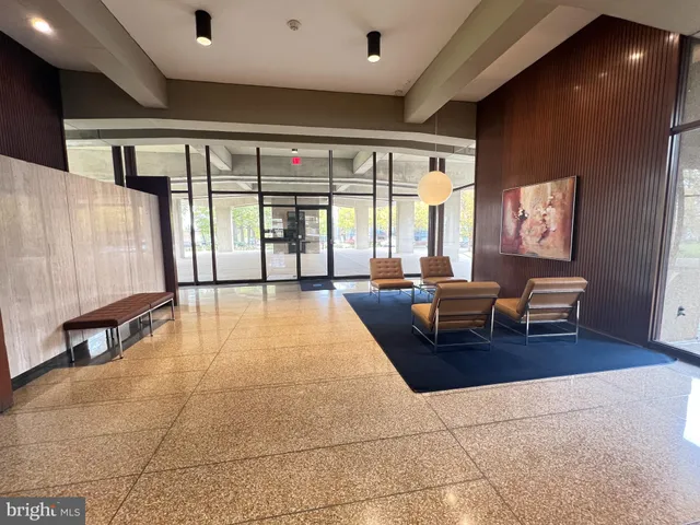 a living room with furniture and large windows