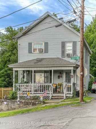 a front view of a house with a yard table and chairs