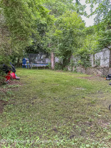 a backyard of a house with trampoline
