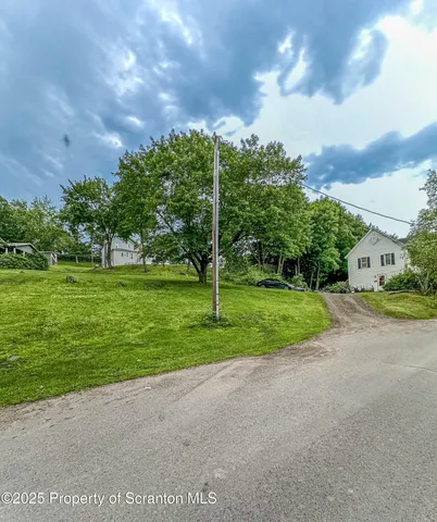 a view of a roadside with trees