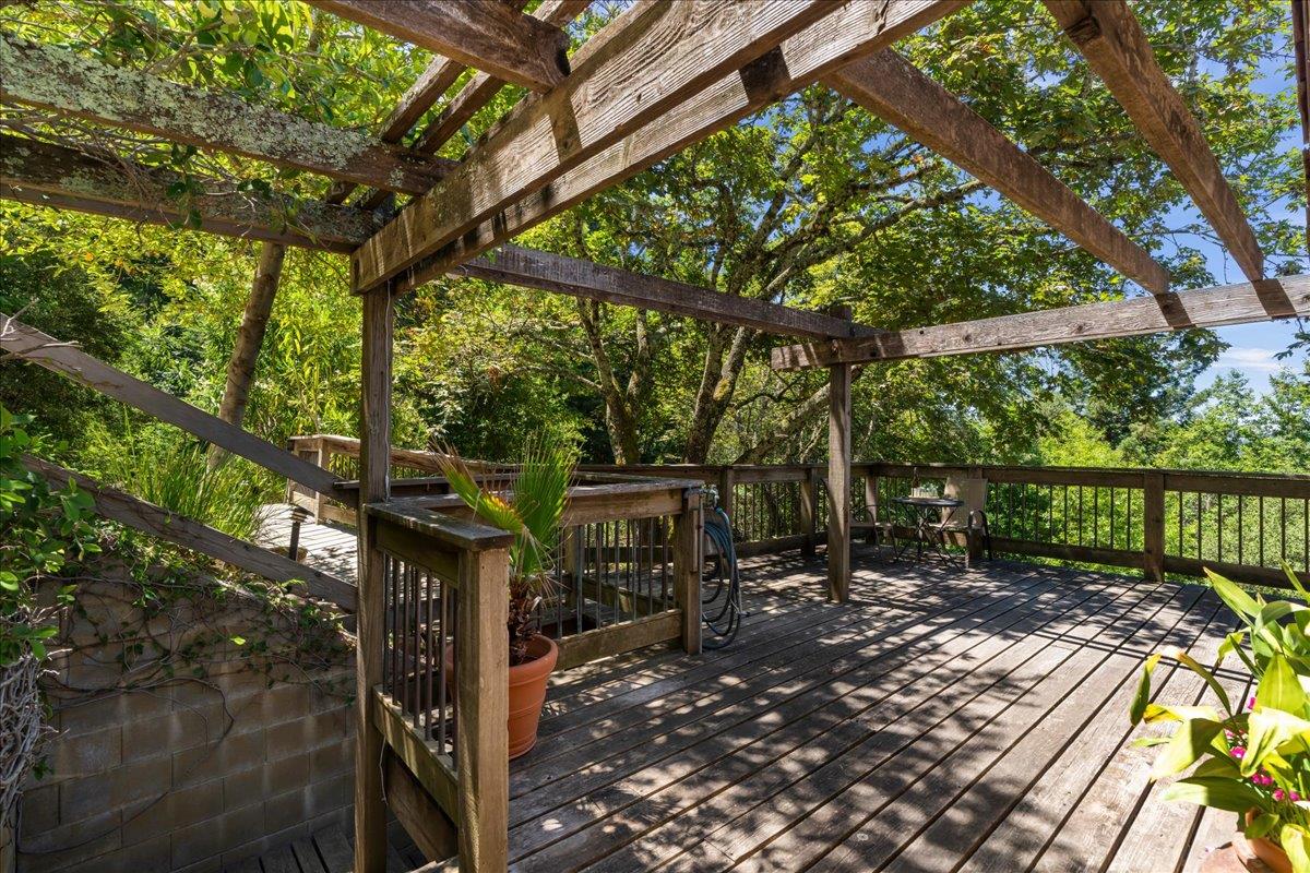 15171 Old Ranch Road Los Gatos, CA 95033 - Photo 20 of 26 a view of a patio with table and chairs with wooden floor and fence