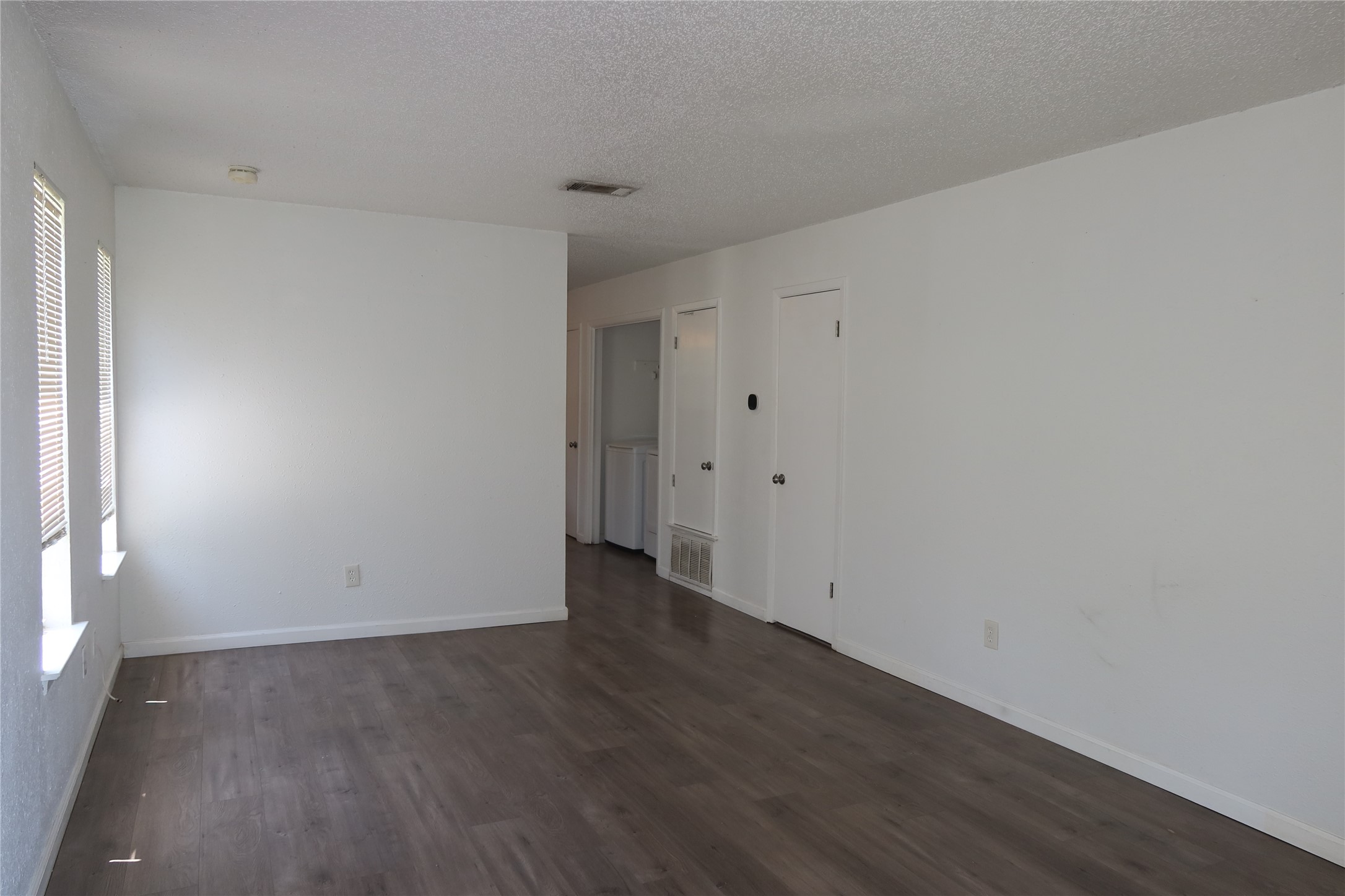 Clean lines and smooth wood flooring define this versatile main living area.