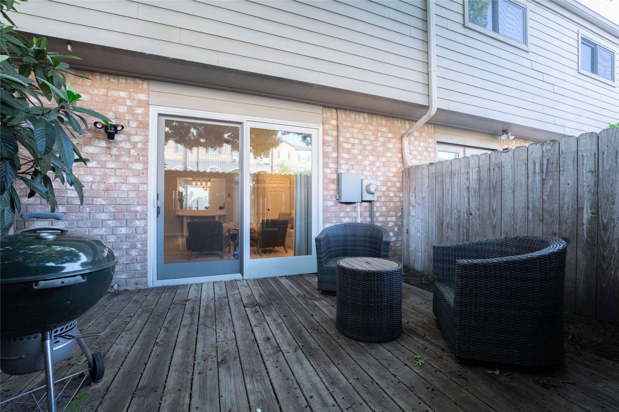 7447 Brompton Street, Unit 7447 Houston, TX 77025 - Photo 25 of 27 Inviting backyard patio offering the ideal space for outdoor entertaining and peaceful mornings with a cup of coffee.