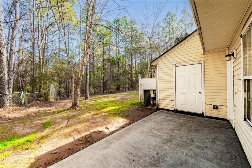 2814 Norfair Loop Lithonia, GA 30038 - Photo 16 of 18 a view of a house with backyard and trees