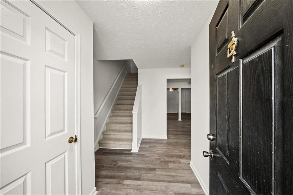 2814 Norfair Loop Lithonia, GA 30038 - Photo 2 of 18 a view of a hallway with wooden floor and staircase