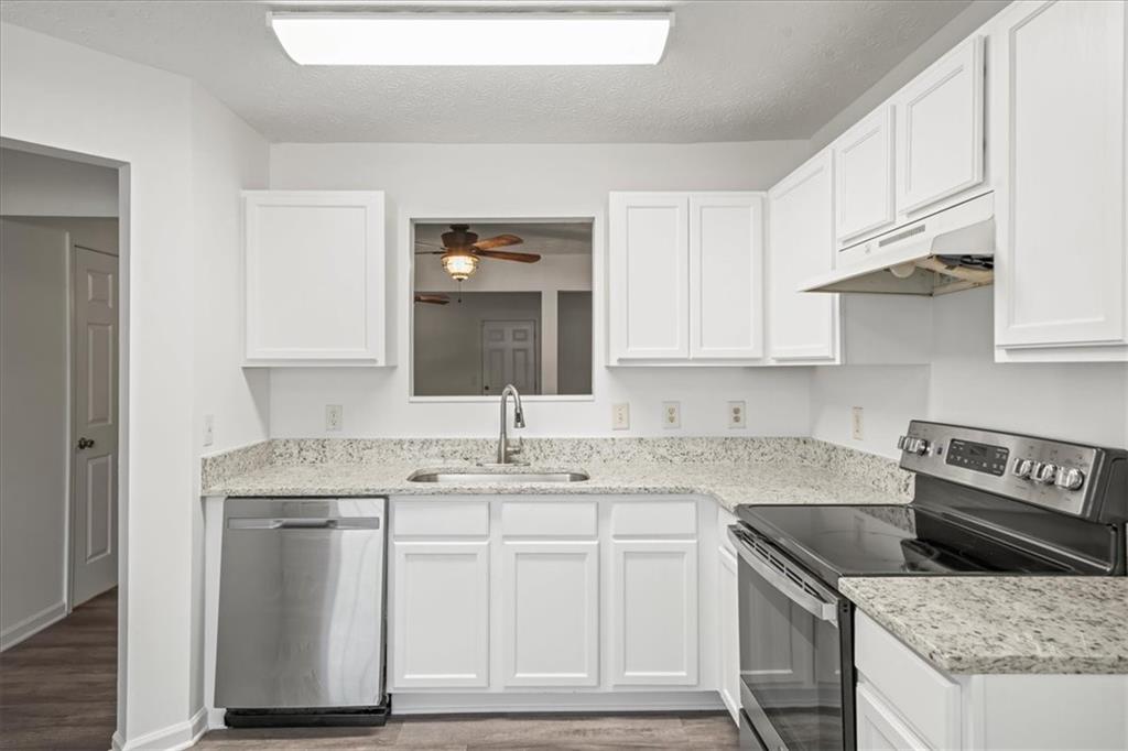 2814 Norfair Loop Lithonia, GA 30038 - Photo 5 of 18 a kitchen with stainless steel appliances granite countertop a sink stove and cabinets