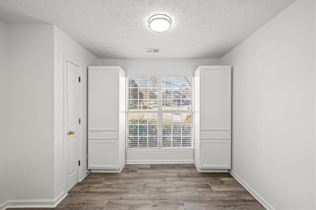 2814 Norfair Loop Lithonia, GA 30038 - Photo 7 of 18 an empty room with wooden floor and windows