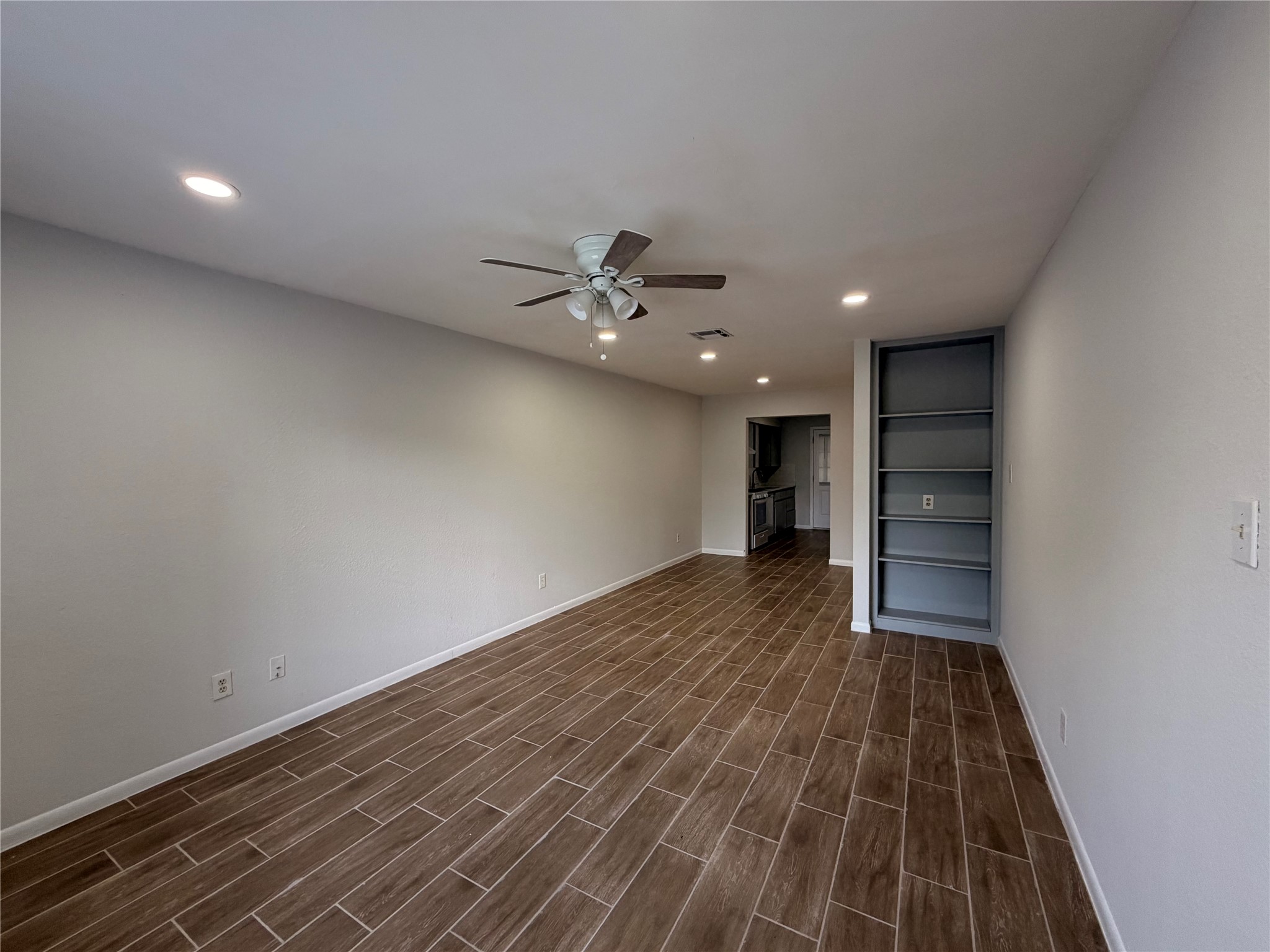 604 Gaylor Street, Unit B Austin, TX 78752 - Photo 2 of 5 Recessed lighting illuminates wood-look tile flooring in this inviting open concept living space.