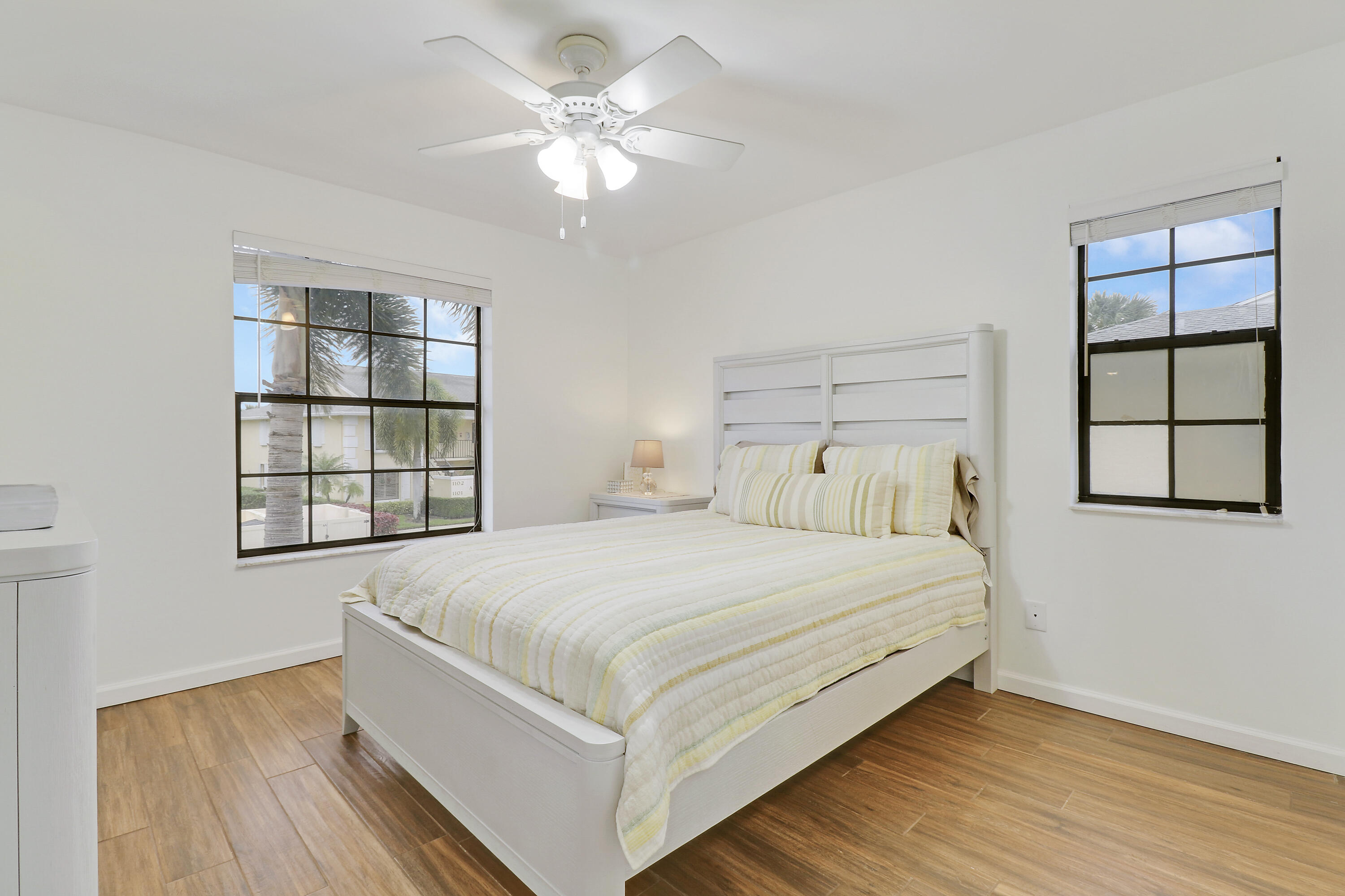 1112 Keystone Drive, Unit A Jupiter, FL 33458 - Photo 22 of 41 a large bedroom with a bed and a window