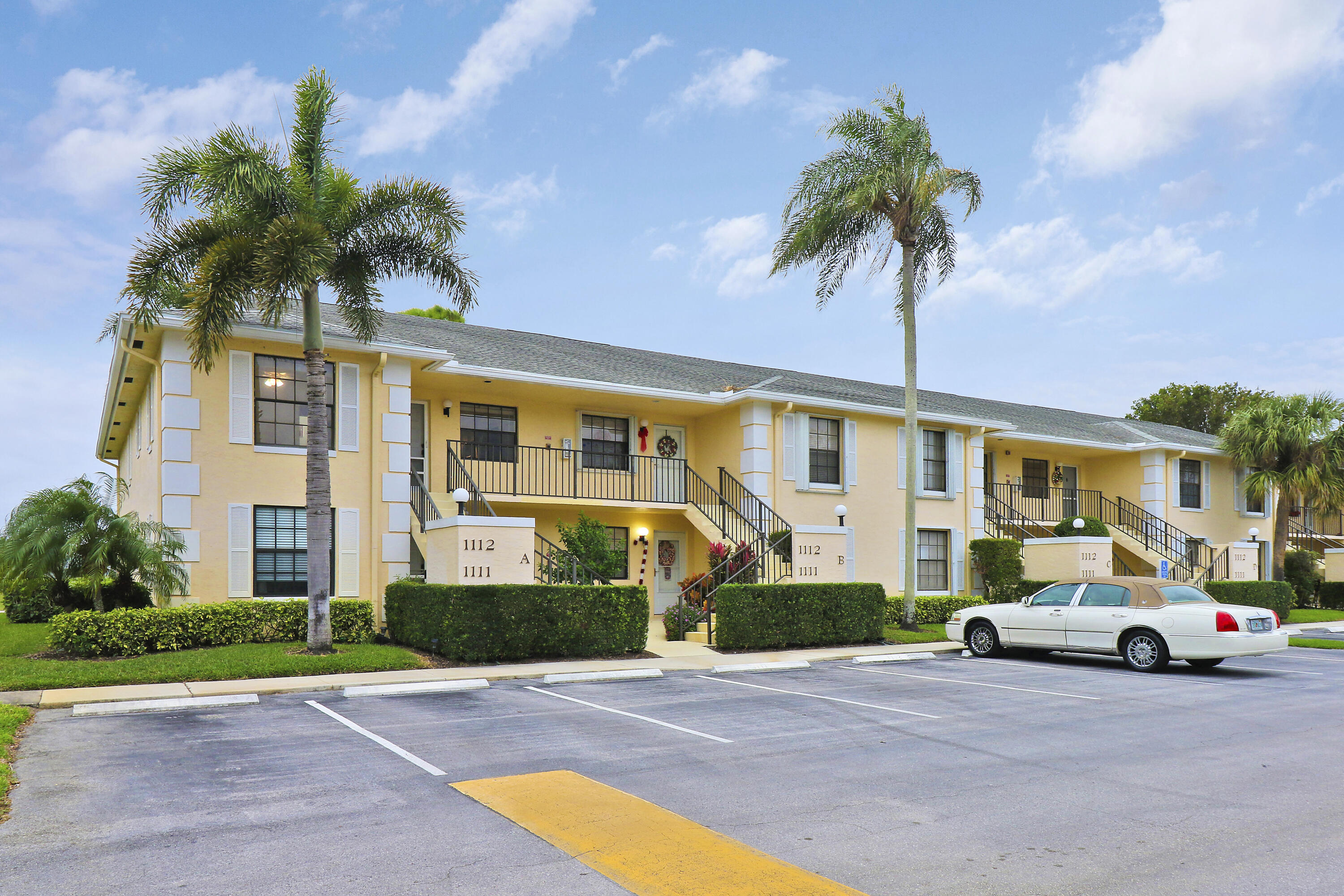 1112 Keystone Drive, Unit A Jupiter, FL 33458 - Photo 40 of 41 a front view of a house with a garden and parking