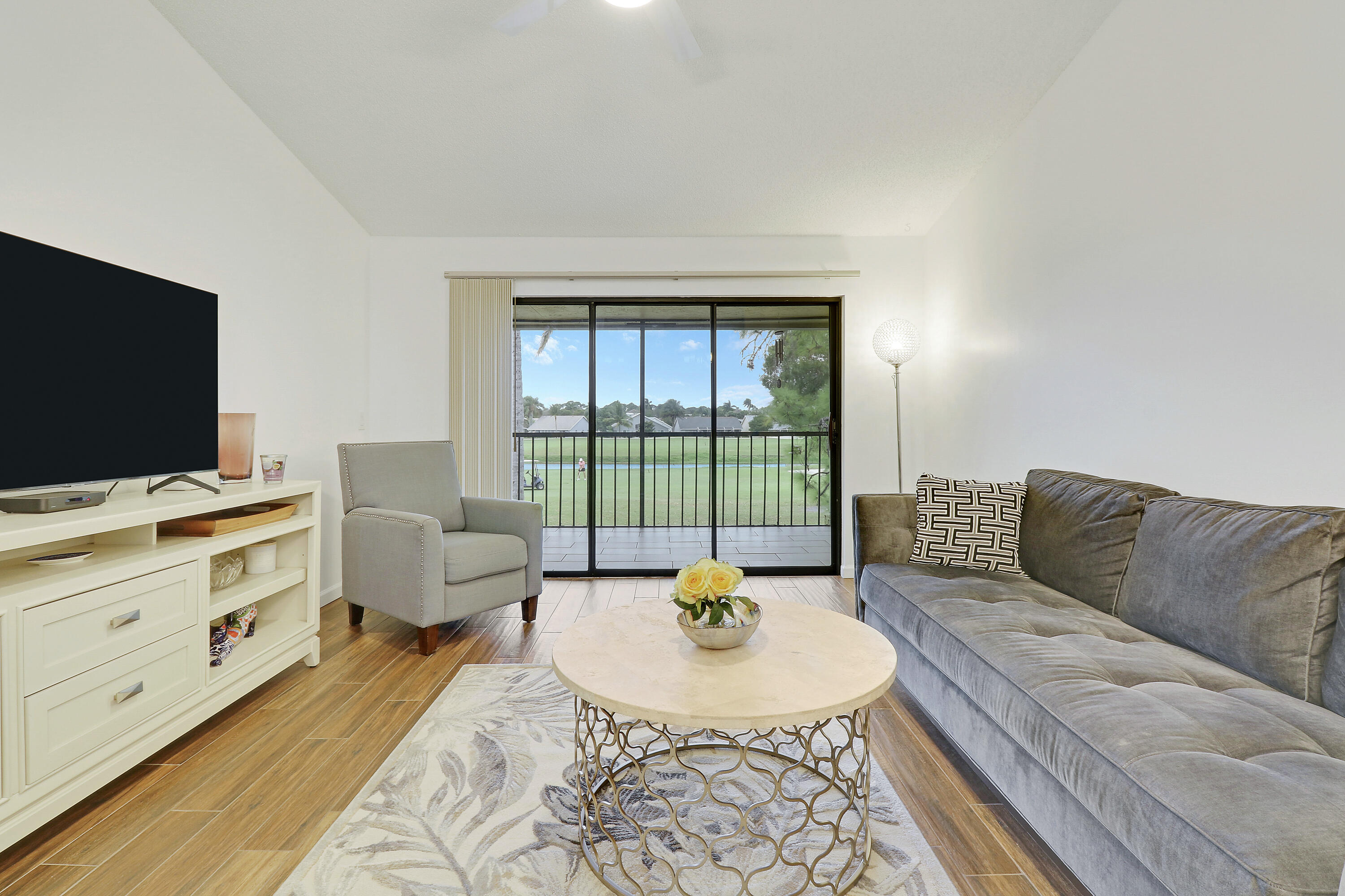 1112 Keystone Drive, Unit A Jupiter, FL 33458 - Photo 4 of 41 a living room with furniture and a flat screen tv