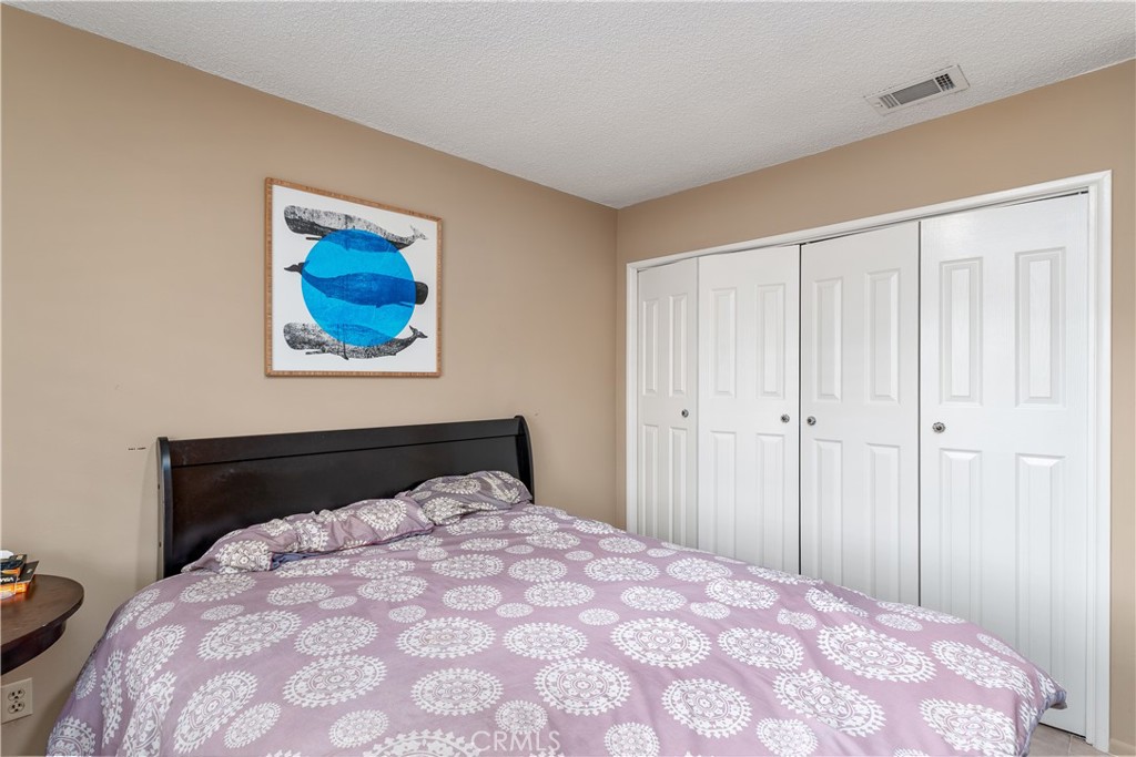 4967 Chapala Drive Riverside, CA 92507 - Photo 29 of 34 a bedroom with a bed and a painting on the wall